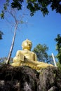 Yellow sitting Budha image with blue sky