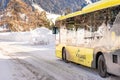 Yellow Ski Bus on snowy road. Ski region Schladming-Dachstein Styria, Austria