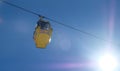 yellow ski lift cabins with snow and trees underneath the blue sunny sky above the ski slopes at wintersport mountains Royalty Free Stock Photo