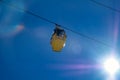 yellow ski lift cabins with snow and trees underneath the blue sunny sky above the ski slopes at wintersport mountains Royalty Free Stock Photo