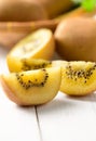 Yellow sliced kiwi fruit on white wood Royalty Free Stock Photo