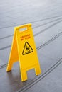 Yellow slippery warning safety caution sign Royalty Free Stock Photo