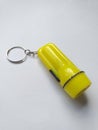 Yellow small flashlight keychain Royalty Free Stock Photo