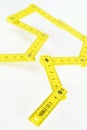 Yellow small folding ruler on white background