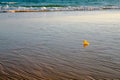 Yellow small toy duckling on beach Royalty Free Stock Photo