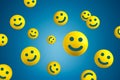 Yellow smiling balls flying on blue background. Happiness or customer satisfaction Royalty Free Stock Photo