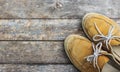 Yellow sneakers from an aerial view on wooden floors.