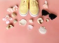Yellow sneakers ,sunglasses and seashell ,spring  flowers on pink background ,shoes for women, clothes and footwear accessories  b Royalty Free Stock Photo