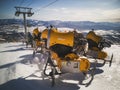 Yellow snow cannons on slope