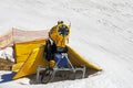 yellow snow generator on a snow slope at a resort on a sunny day. Royalty Free Stock Photo