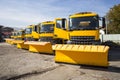 Yellow snowplow trucks in line
