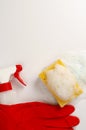 Yellow soapy sponge with foam, red gloves and bottle with detergent Royalty Free Stock Photo