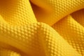 Yellow soccer fabric abstract background. Close-up of fabric folds