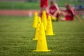 Yellow soccer training cones on grass field Royalty Free Stock Photo