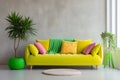 Yellow sofa with colorful pillows and green plant in pot near a blank grey wall. Modern interior for mockup, wall art. Promotion Royalty Free Stock Photo