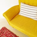 Yellow sofa with striped cushion Royalty Free Stock Photo