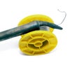 Yellow soldering tin roll with a soldering iron Royalty Free Stock Photo