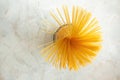 Yellow spaghetti in glass jar on marble kitchen table. Ingredient for Italian pasta. Raw food and cookware Royalty Free Stock Photo