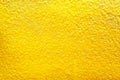 Yellow sparkle paint on concrete wall surface in rough seamless patterns for background Royalty Free Stock Photo