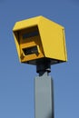 Yellow speed safety camera with blue sky.