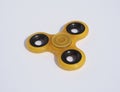 Yellow spinner toy on a white background