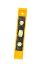 Yellow spirit level tool isolated on white background, used for precise alignment and construction measurement. Royalty Free Stock Photo