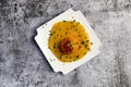 Yellow split pea puree with meatball on a white square  plate on a dark background Royalty Free Stock Photo