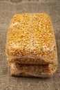 Yellow split peas in a cellophane bag on a background of coarse-textured burlap. Traditional grains for making soups and porridges Royalty Free Stock Photo