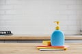Yellow sponge and blue plastic bottle with liquid soap on wooden table with color cloths, kitchen background Royalty Free Stock Photo
