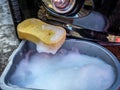 Sponge and water to clean the front bumper of a black car