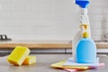 Yellow sponge and two plastic bottle on wooden table with color cloths , kitchen background Royalty Free Stock Photo