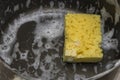 Sponge for washing dishes in the sink in the kitchen Royalty Free Stock Photo