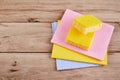 Yellow sponge on wooden table with color cloths, top view Royalty Free Stock Photo