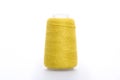 Yellow spool of thread isolated on white background. Skein of woolen threads. Yarn for knitting. Materials for sewing