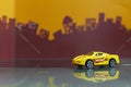 Yellow Sport racer car toy selective focus on blur city background