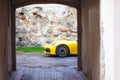 Yellow sports car in the ancient courtyard of the old city Royalty Free Stock Photo