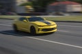 Yellow sports car racing down the city street Royalty Free Stock Photo