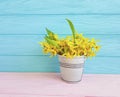 Yellow spring flowers easter rustic vintage border seasonal on blue wooden background Royalty Free Stock Photo
