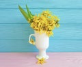 Yellow spring flowers easter vintage border seasonal on blue wooden background Royalty Free Stock Photo