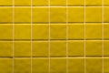 Yellow square ceramic tile wall texture background.