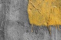 Yellow square with peeling paint on gray plastered wall background. Grunge texture. copy space