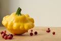 Yellow squash with cowberries on the wooden table