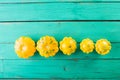 Yellow squash on a wooden turquoise background.