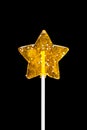 Yellow star candy on black Royalty Free Stock Photo