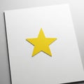 A yellow star is positioned centrally on a plain white sheet of paper Royalty Free Stock Photo