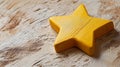 Yellow star on wooden surface, close-up view. Decorative element and design concept Royalty Free Stock Photo