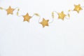 Yellow stars on a string - Winter holidays and New Year Eve composition. Flat lay, top down view with copy space
