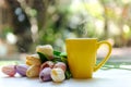 Yellow steaming cup of hot coffee on white wooden near window Royalty Free Stock Photo