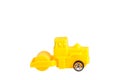 Yellow steamroller toy isolated on white background. Royalty Free Stock Photo