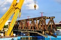 yellow steel floating crane on the river. the largest bridge building crane on the Danube river